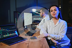 Team of traders working at monitor computer and browsing online in trading office