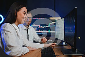 Team of traders working at monitor computer and browsing online in trading office