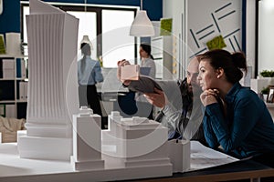 Team of two architect colleagues using smartphone in videocall conference