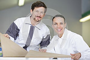 team two painters smiling at camera