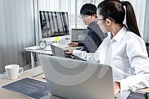 Team of two professional programmers working on website projects in software development on the desktop computer and making coding