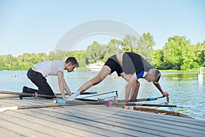 Team of two teenage boys kayaking on river