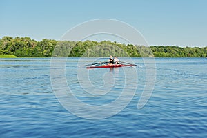 Team of two teenage boys kayaking on river