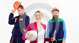 Team of two workmen and woman standing grouped