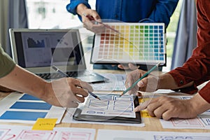A team of UI UX web designers is working together to develop a mobile responsive website by previewing UI UX Front
