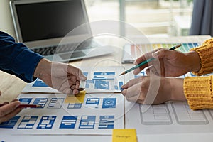 A team of UI UX web designers is working together to develop a mobile responsive website by previewing UI UX Front