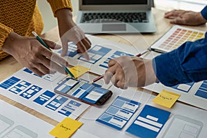 A team of UI UX web designers is working together to develop a mobile responsive website by previewing UI UX Front