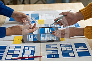 A team of UI UX web designers is working together to develop a mobile responsive website by previewing UI UX Front
