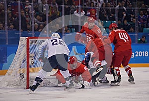 Team United States in white in action against Team Olympic Athlete from Russia Men`s ice hockey preliminary round game