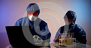 Team of virologists are working in laboratory, exploring coronavirus, two scientists photo
