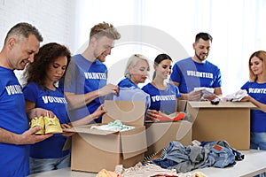 Team of volunteers collecting donations in boxes