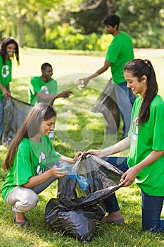 Team of volunteers picking up litter in park