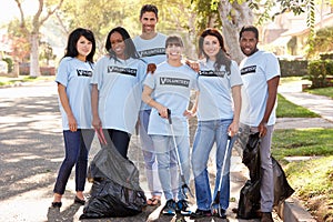 Team Of Volunteers Picking Up Litter In Suburban Street