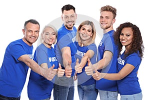 Team of volunteers in  showing thumbs up on white background photo