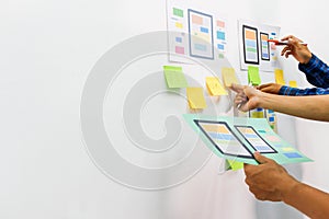 The team of website designers with the ux ui system are writing programs and laying the layer to determine the display style with