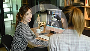 Team of website developer, software engineer working on a new project, writing program code on computer in office