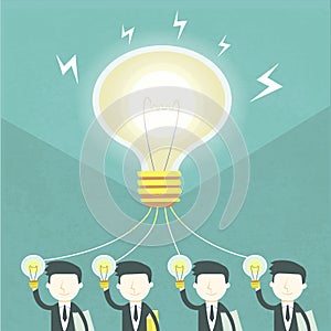 Team work concept with bulb and businessmen