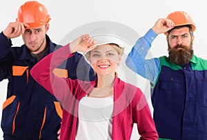 Team work concept. Woman and men holds hard hats