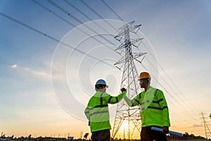 Team work of Engineers and Technician join hands for success after work inspections at the electric power station, electricity