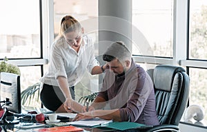 Team work in the office. Secretary brings the papers for signature to the boss.