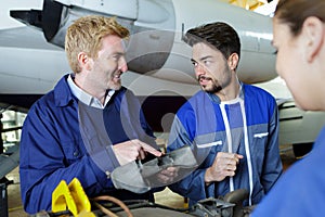 team workers assembling aircraft