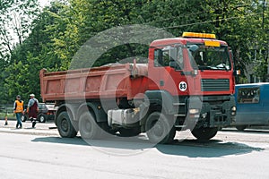 Team of workers in protective uniforms work on road construction. Workers transportation equipment construction