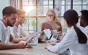 Team Working At Desks In Busy Office photo