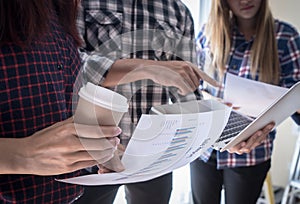 Team are working together analyzing data on laptop