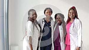 The team of young African American female doctors is happy with the success in their studies and work