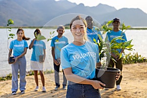 Team of young Asian diversity volunteer worker group enjoy charitable social work outdoor in tree forest planting NGO work for