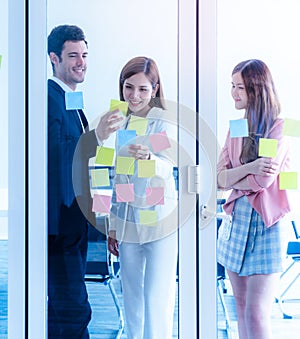 Team of young business man woman standing in meetin room windows