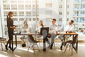 A team of young businessmen working and communicating together in an office. Corporate businessteam and manager in a