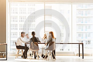 A team of young businessmen working and communicating together in an office. Corporate businessteam and manager in a