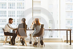 A team of young businessmen working and communicating together in an office. Corporate businessteam and manager in a