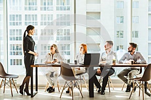 A team of young businessmen working and communicating together in an office. Corporate businessteam and manager in a