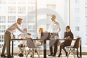 A team of young businessmen working and communicating together in an office. Corporate businessteam and manager in a