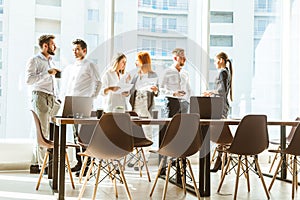 A team of young businessmen working and communicating together in an office. Corporate businessteam and manager in a