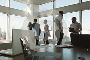 A team of young businessmen working and communicating together in an office. Corporate businessteam and manager in a