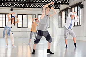 Team of young dancers training moves