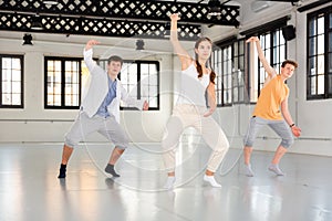 Team of young dancers training moves