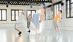 Team of young dancers training moves