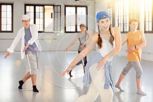 Team of young dancers training moves