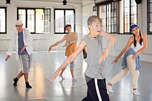 Team of young dancers training moves