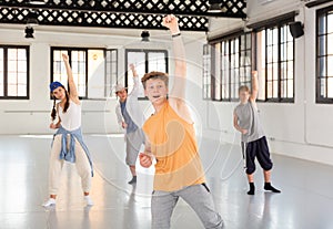 Team of young dancers training moves