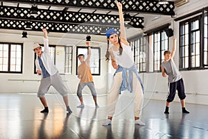 Team of young dancers training moves