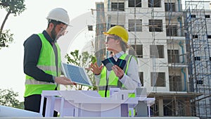 Team young engineer or architect meeting and planning installation solar panel at construction site.