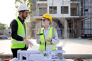 Team young engineer or architect meeting and planning installation solar panel at construction site.