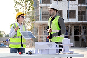 Team young engineer or architect meeting and planning installation solar panel at construction site.