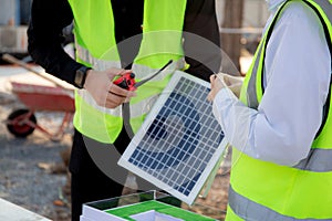 Team young engineer or architect meeting and planning installation solar panel at construction site.