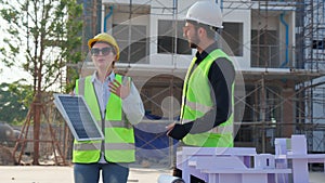 Team young engineer or architect meeting and planning installation solar panel at construction site.